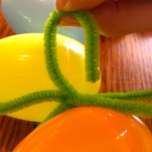 making a pipe cleaner bow on Easter wreath