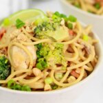 two bowls of homemade peanut noodles with chicken and vegetables