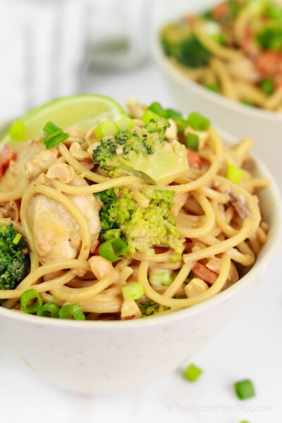 two bowls of homemade peanut noodles with chicken and vegetables
