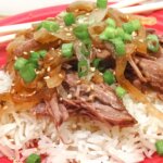 tender shredded beef roast served with rice and caramelized onions