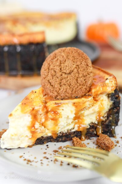 slice of pumpkin cheesecake with caramel drizzle and gingersnap cookie on top
