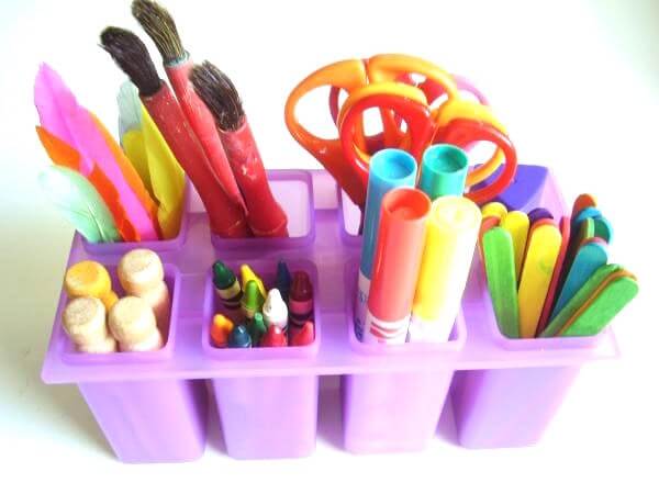 markers and scissors organized in a popsicle mold