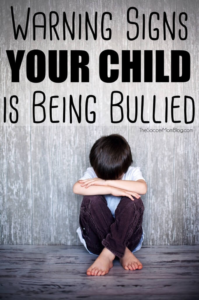 child huddled in a corner; text overlay "Warning Signs Your Child is Being Bullied"