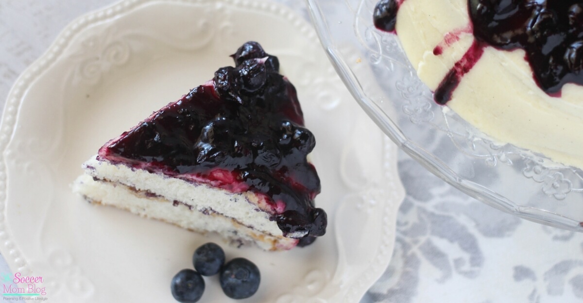 Sweet-and-tart, sticky blueberry pie topping over luscious vanilla buttercream frosting & soft vanilla cake — Blueberry Pie Cake is a truly perfect dessert!