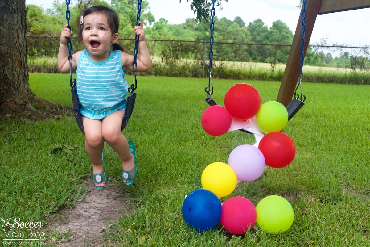 Celebrate a milestone birthday with adorable two year old photos! This fun and colorful balloon themed photography shoot is super easy to create.