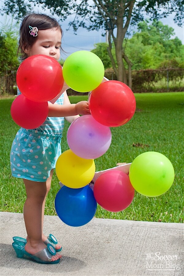 Celebrate a milestone birthday with adorable two year old photos! This fun and colorful balloon themed photography shoot is super easy to create.