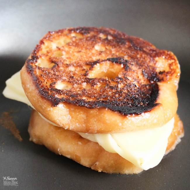 cooking a grilled cheese sandwich made with donuts