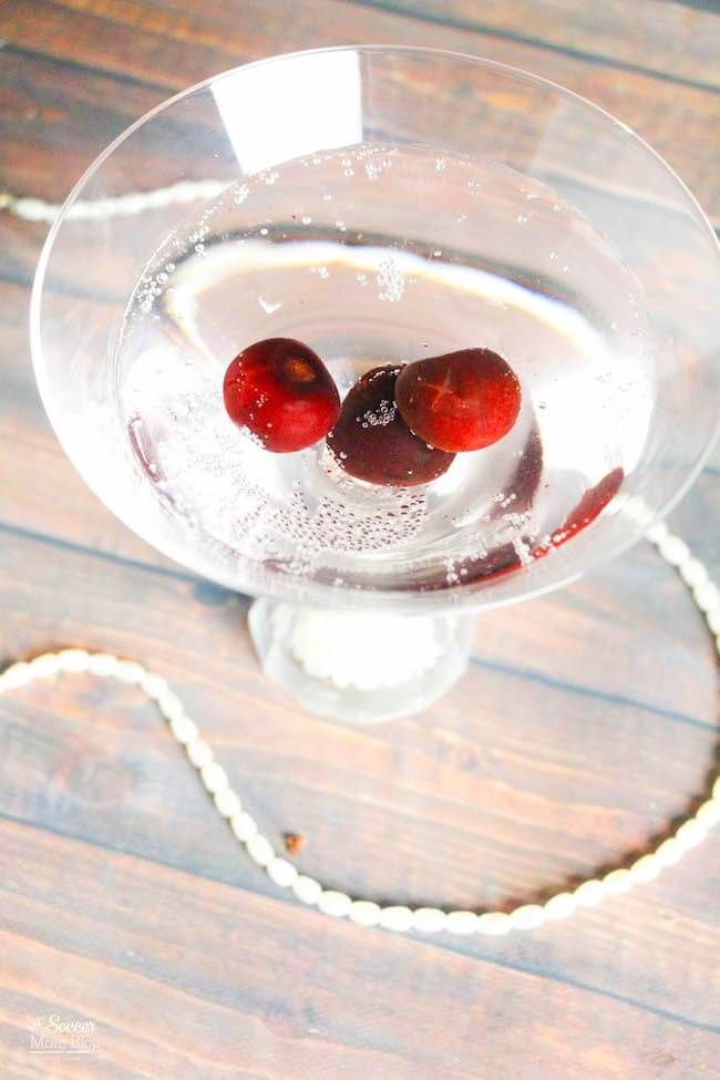 clear sparkling martini with black cherries