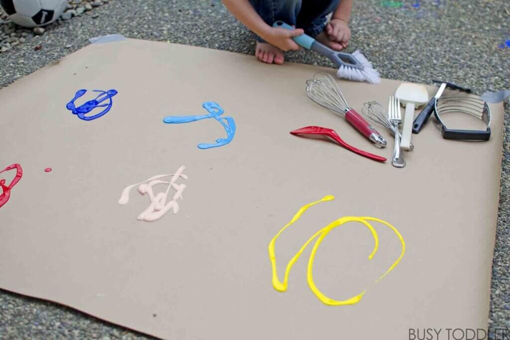 kids painting with kitchen utensils