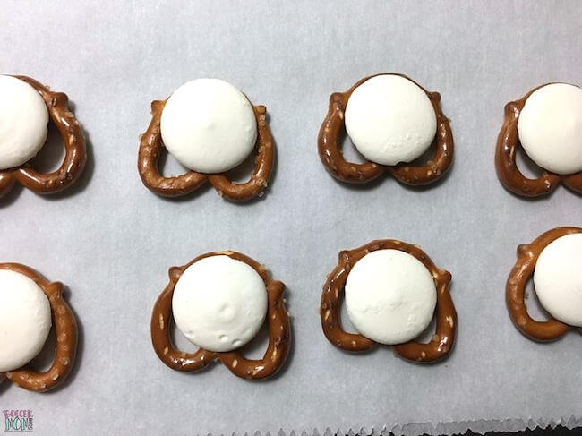 mini pretzel twists with melted white chocolate wafer on top