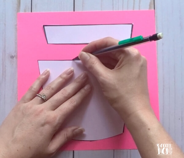 tracing a cupcake pattern on pink paper