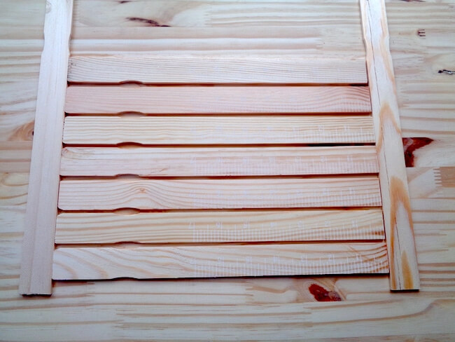 measuring wooden paint sticks to make an American flag