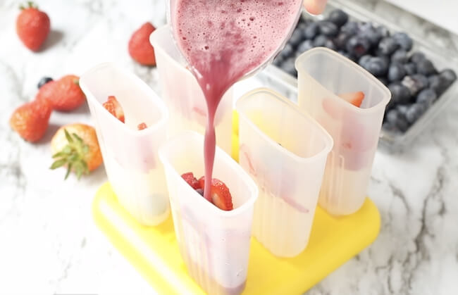pouring wine pops mixture into popsicle molds