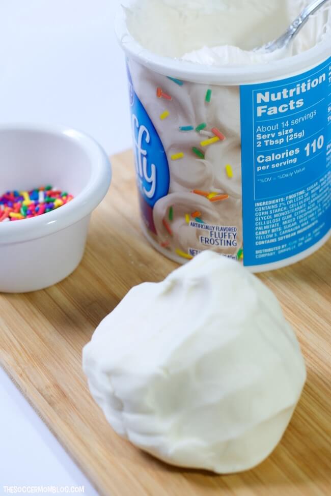 homemade birthday cake play dough, can of frosting, and sprinkles
