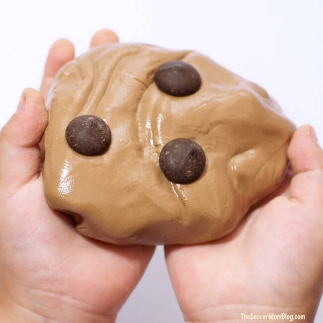 chocolate slime in kid's hands with chocolate chips