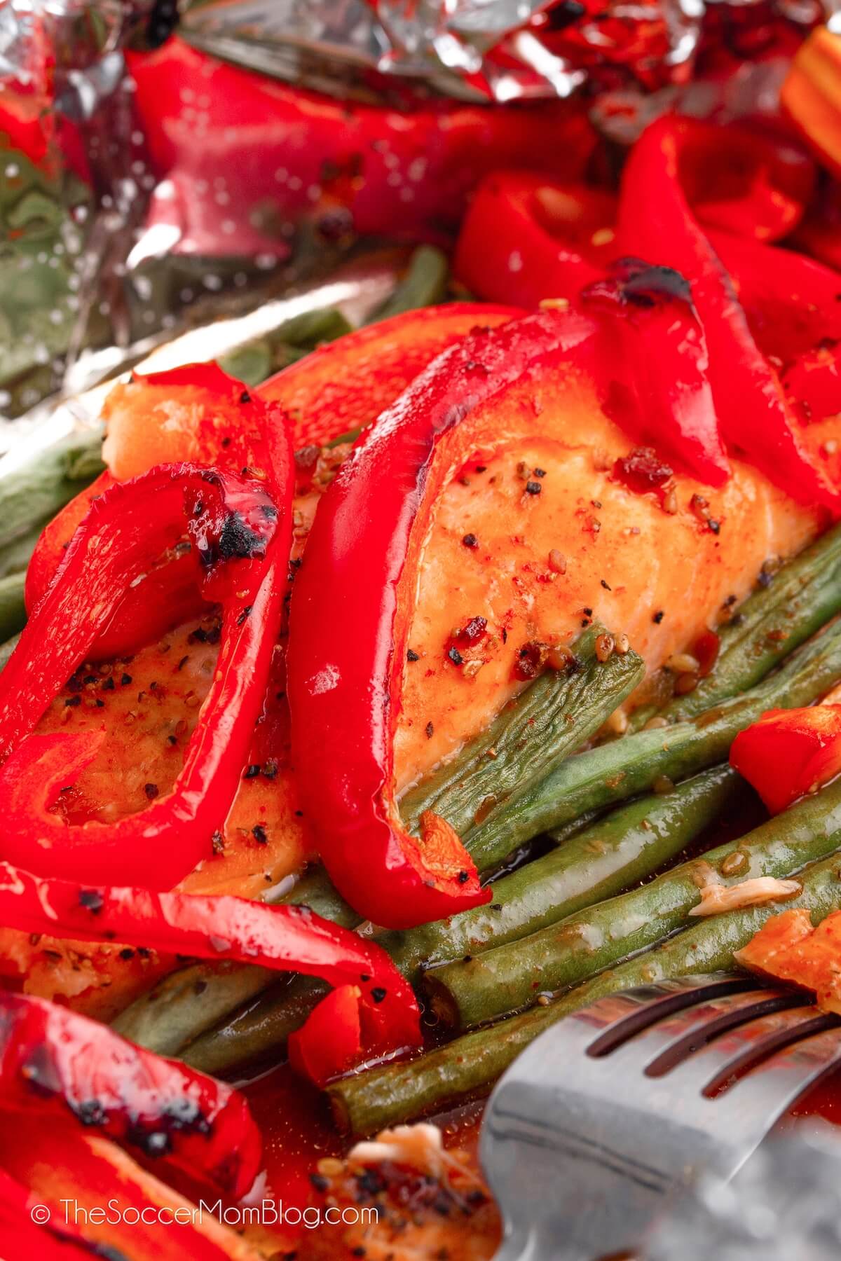 close up of a salmon filet cooked in foil, with veggies