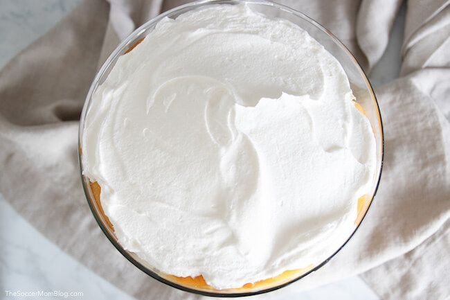 peach trifle dessert recipe, topped with whipped cream