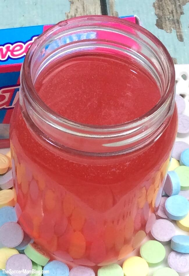 Just as much fun to make as it is to drink! Shake it up with this Sweet Tarts Moonshine Recipe! An easy homemade infused alcohol tutorial.