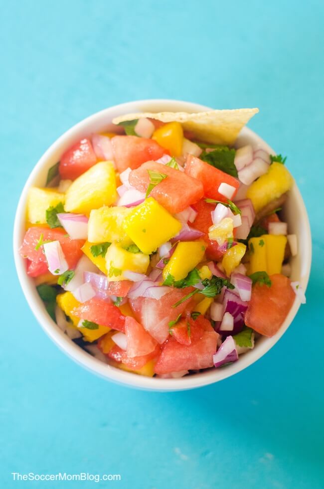 top-down photo of mango salsa on blue background