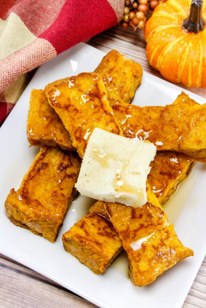 plate of pumpkin French toast sticks, with a pat of butter