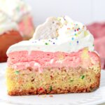 slice of cheesecake with funfetti cake bottom and pink cheesecake on top