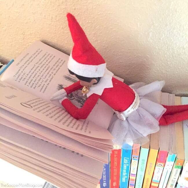 elf doll reading a book