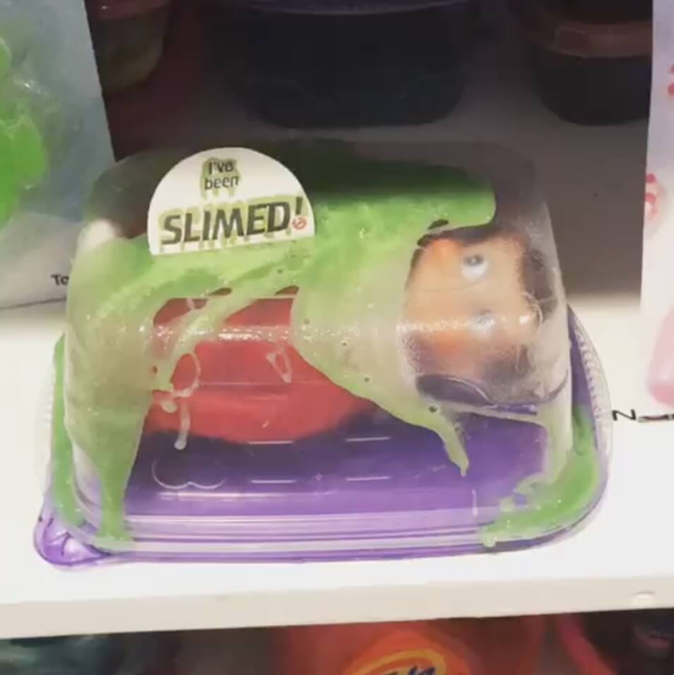 elf doll in a plastic container full of slime
