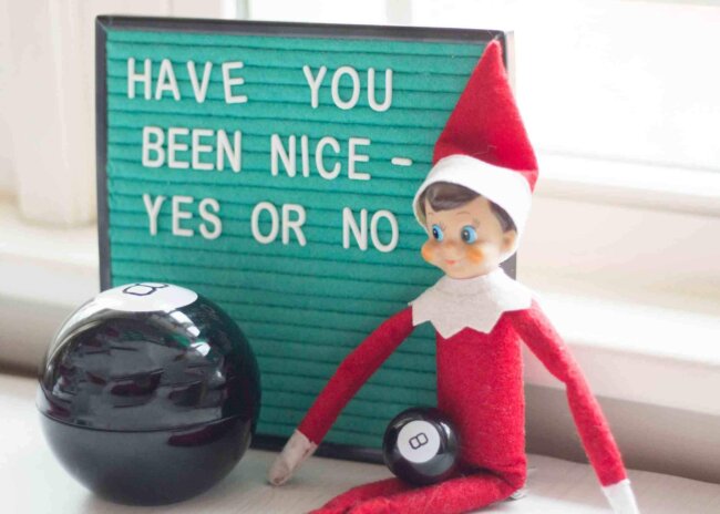 elf on the shelf with letter board and magic 8 ball