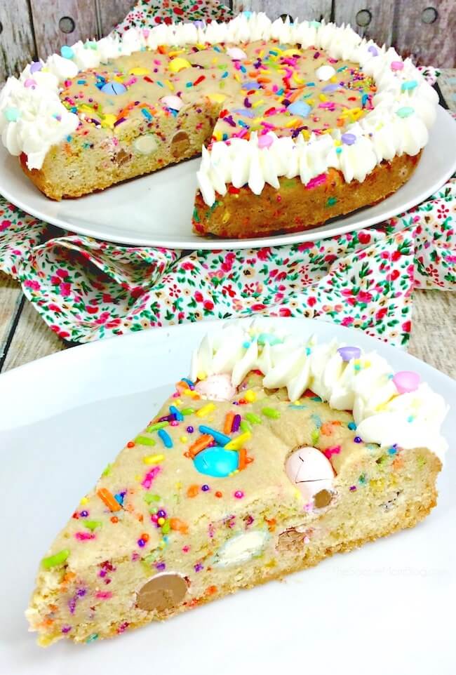 cookie cake filled with Easter candy, a slice and the whole cake in background