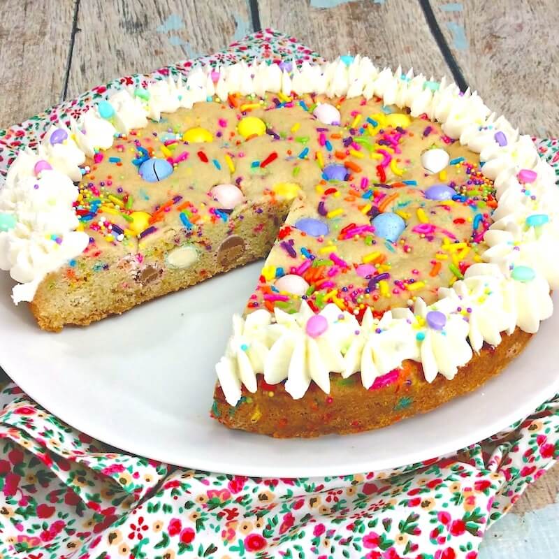 whole cookie cake (with one slice missing) filled with Easter candy