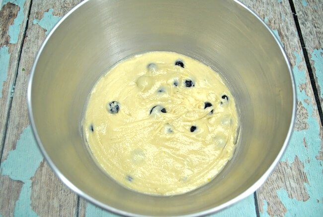 Lemon donut batter in bowl with blueberries