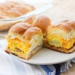 Hot and hearty breakfast sliders right out of the oven are guaranteed to make mornings amazing!! Baked til' golden brown with hot cheesy goodness inside. An easy family recipe ready from start to finish in 30 minutes.