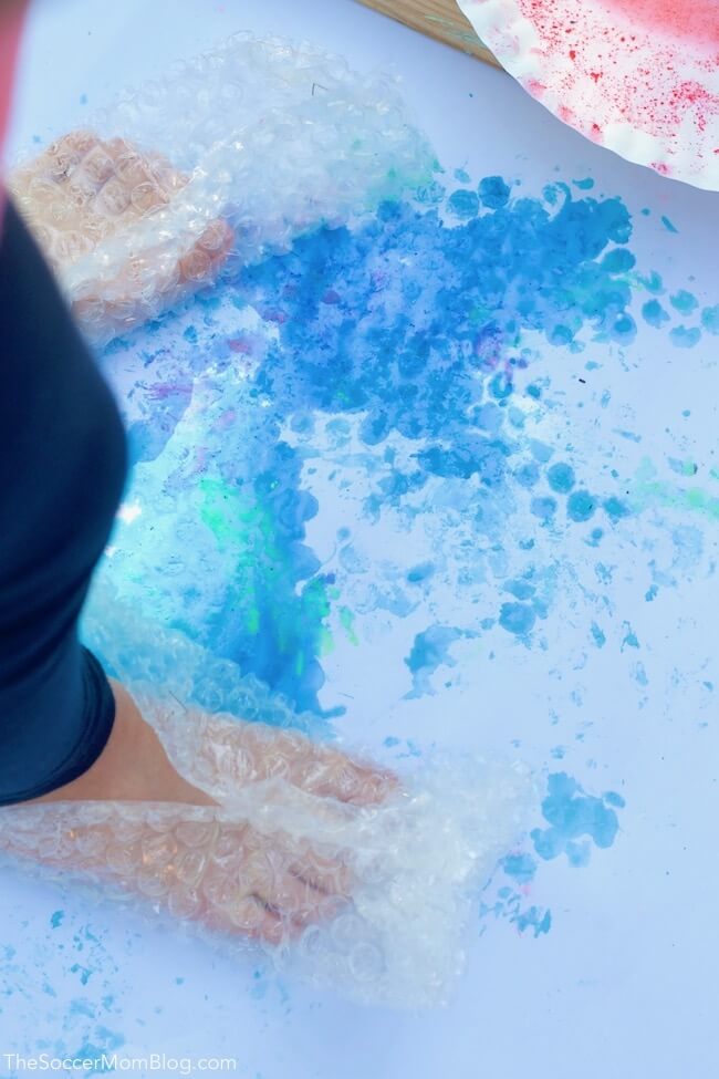 Painting with bubble wrap on kids feet