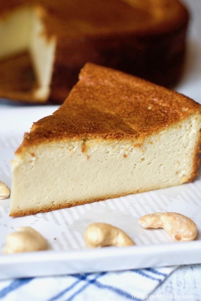 slice of cashew cheesecake with nuts on plate