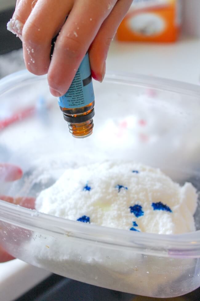 Adding blue food coloring to white slime