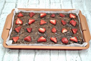 Chocolate brownies topped with fresh strawberries