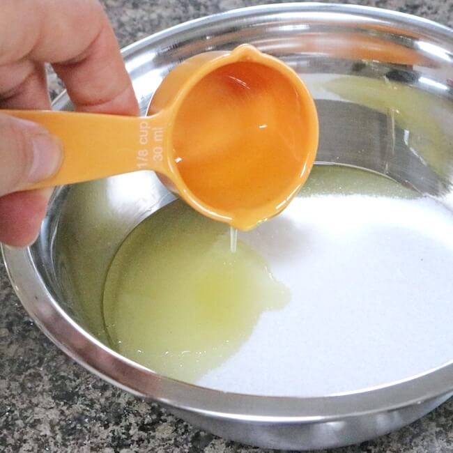 Adding honey to mixing bowl for homemade lip scrub