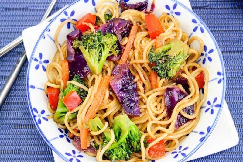 Easy lo mein recipe on plate with blue background