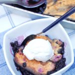 Our favorite family recipe! This fluffy cake-style gluten free blueberry cobbler is a guilt-free version of the classic summer dessert!