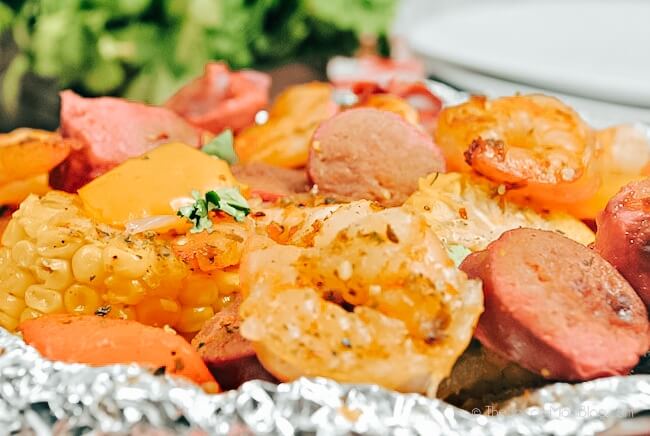 close up of cajun shrimp with sausage and veggies