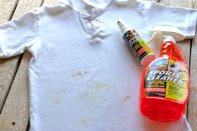 Grass stained white shirt and ESPRO sports cleaner bottles