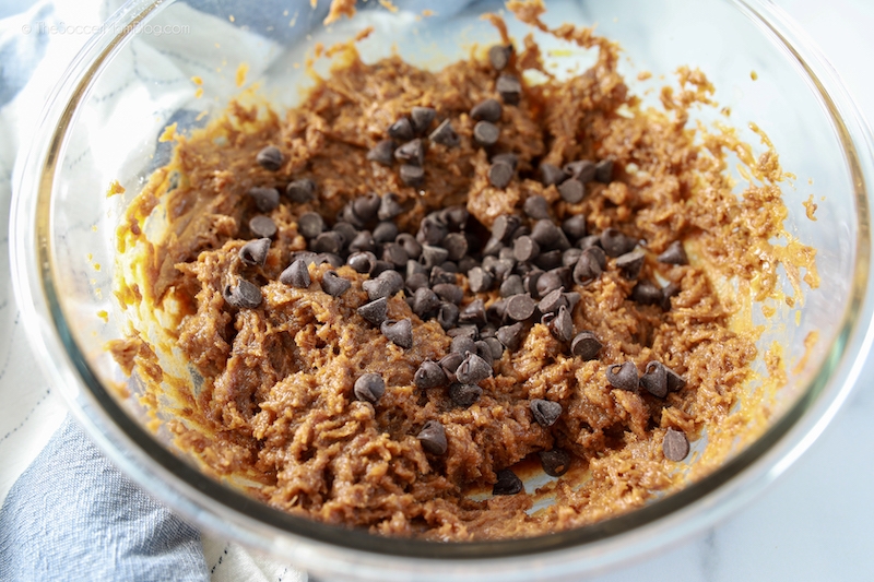 adding chocolate chips to cookie batter