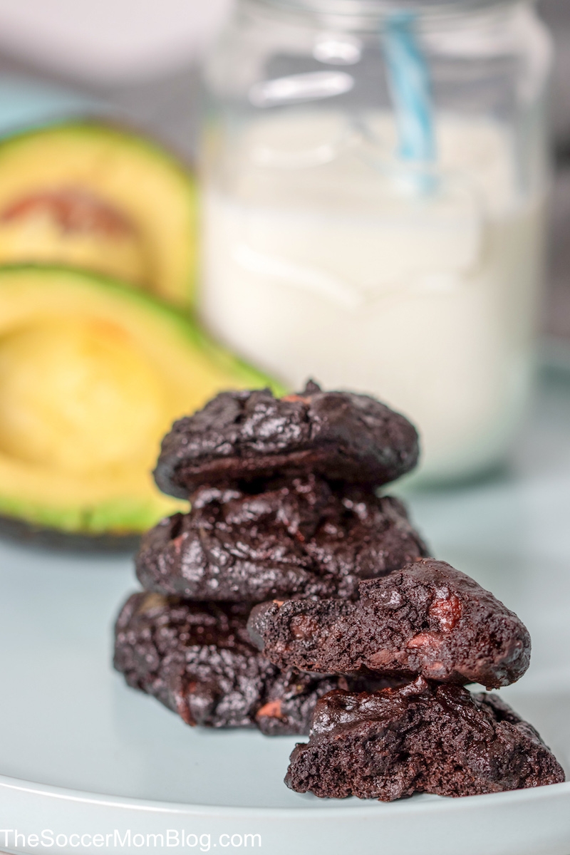 stack of chocolate cookies with milk and avocados.