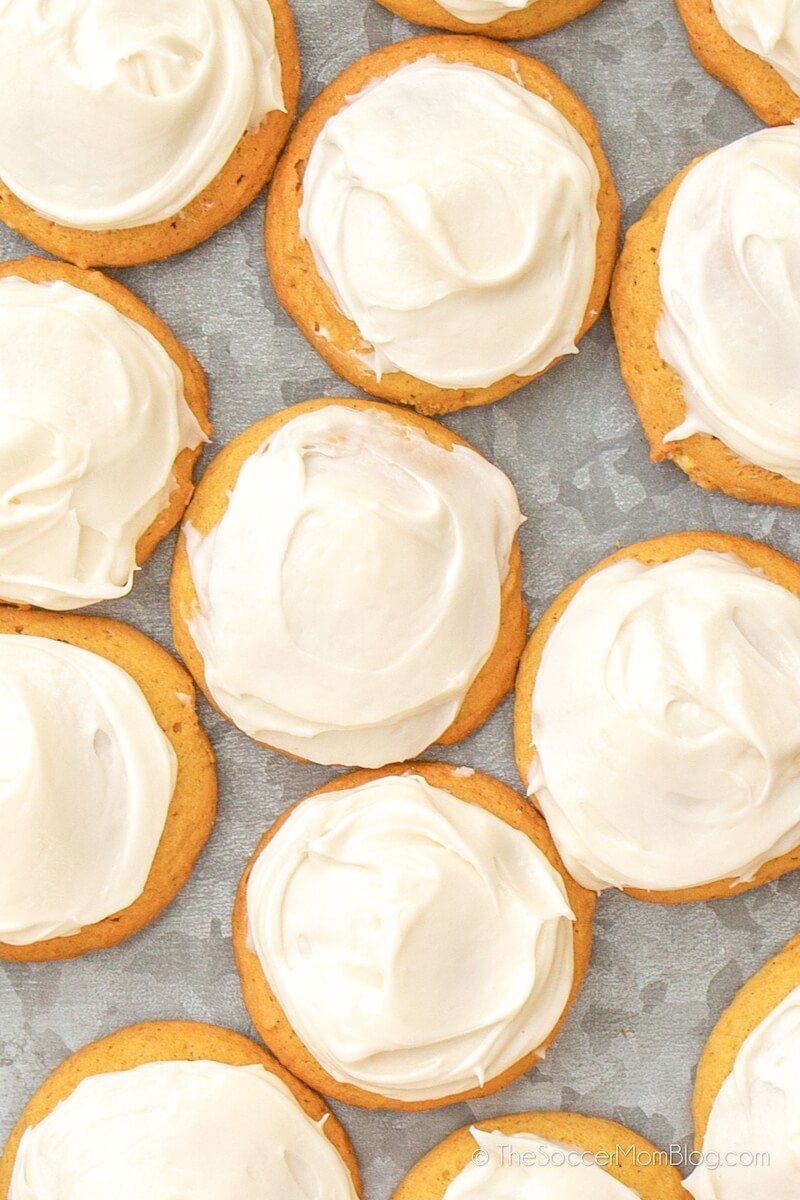 baking sheet covered with iced pumpkin cookies