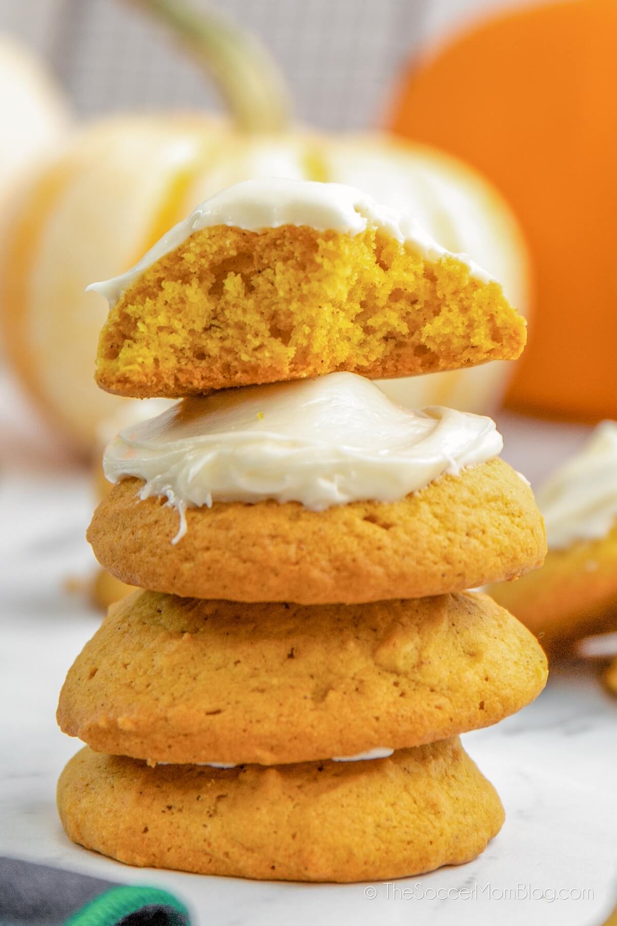 stack of pumpkin cookies with cream cheese icing