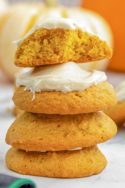 stack of pumpkin cookies with cream cheese icing