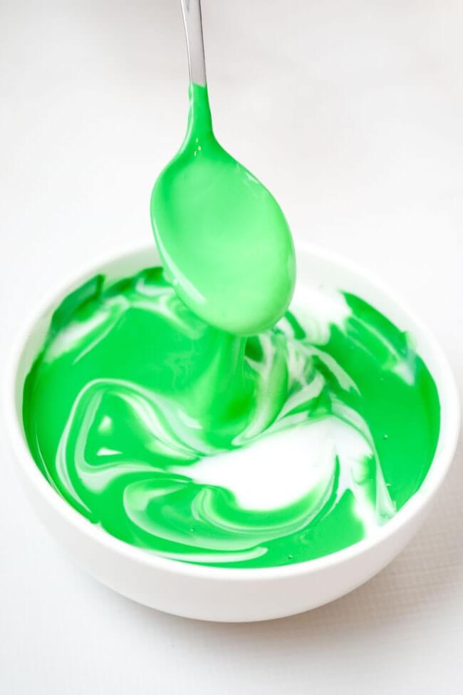adding green acrylic paint to white glue slime
