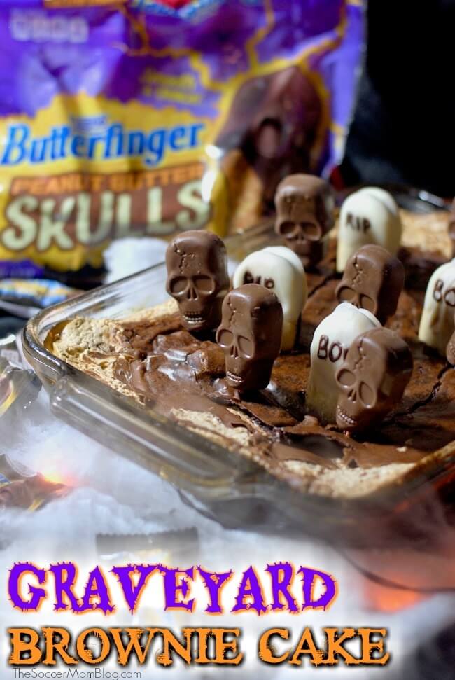 Graveyard Cake is a spooktacular Halloween party recipe made with rich brownie, creamy marshmallow, and crunchy Butterfinger Peanut Butter Skulls.