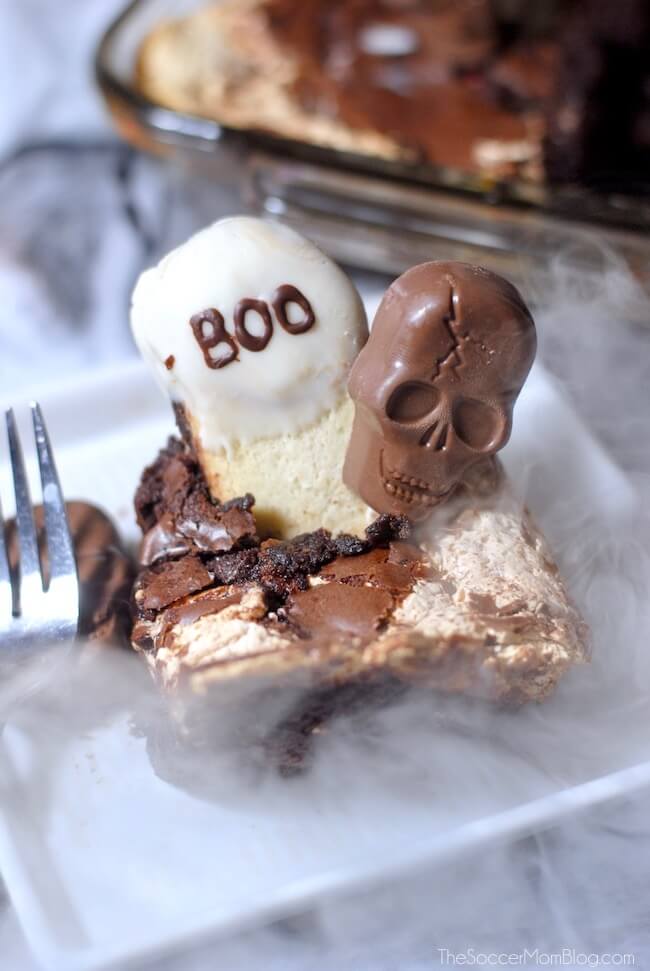 Graveyard Cake is a spooktacular Halloween party recipe made with rich brownie, creamy marshmallow, and crunchy Butterfinger Peanut Butter Skulls.