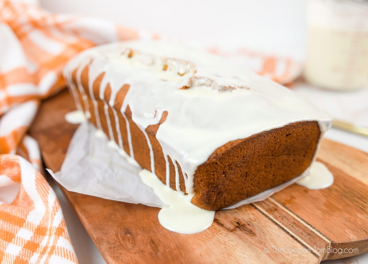 white chocolate icing dripping on a loaf of homemade pumpkin bread